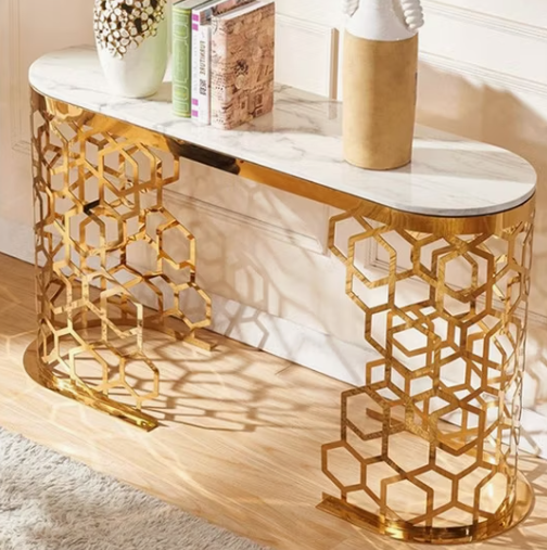 Decorative console table with gold geometric design and marble top.