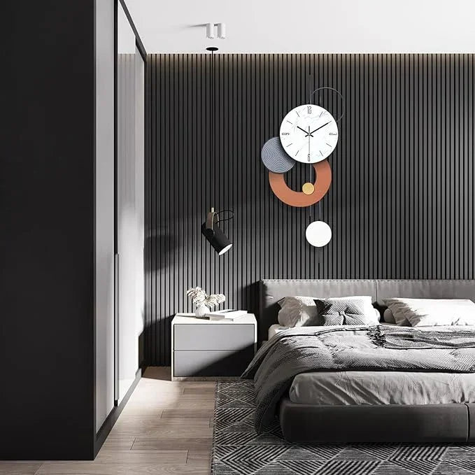 Modern bedroom with a gray bed, nightstand, and decorative wall clock.