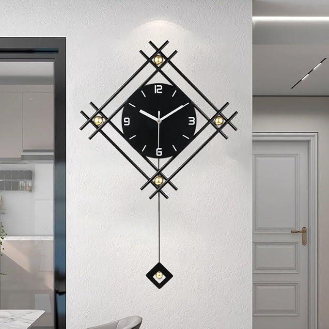 Decorative wall clock with black face and gold accents on a white wall.