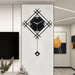 Decorative wall clock with geometric design on a wall in a modern interior setting.