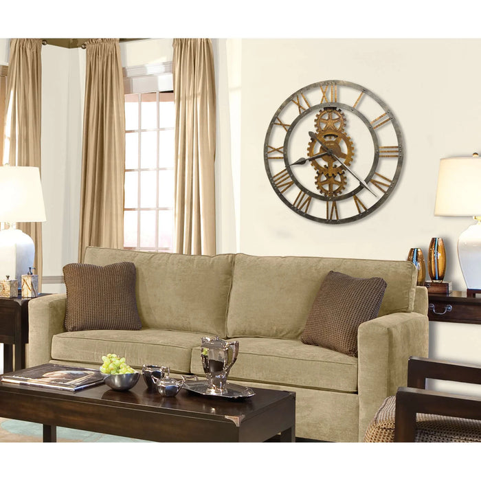 Living room with a green sofa, decorative pillows, and a large wall clock.