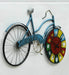 Decorative wall clock shaped like a bicycle with a colorful clock face on a white background
