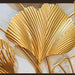 Gold leaf decorative wall art on a light background