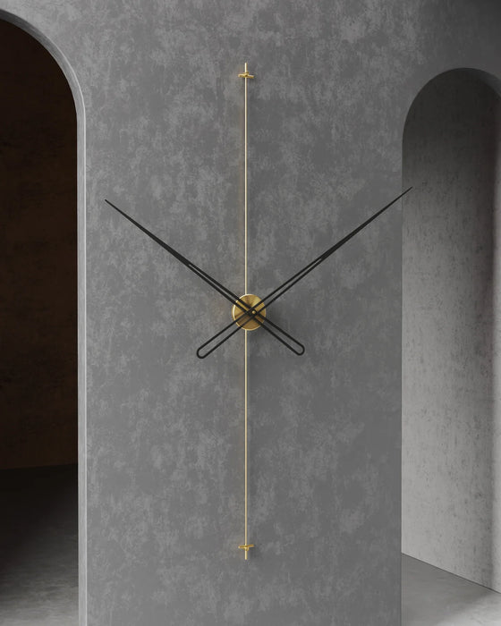 Modern wall clock with gold accents on a gray concrete wall