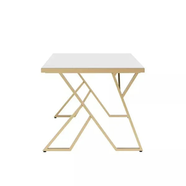 table with a white marble top and gold metal frame on a white background