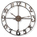 Decorative wall clock with metallic finish on a white background