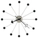 Modern wall clock with black and white design on a white background