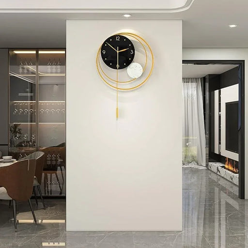 Modern wall clock with gold accents on a white wall in a stylish interior setting.