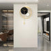 Modern wall clock with gold accents on a white wall in a stylish interior setting.