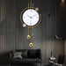 Decorative wall clock for hall with gold accents on a dark wooden wall above a black sofa.