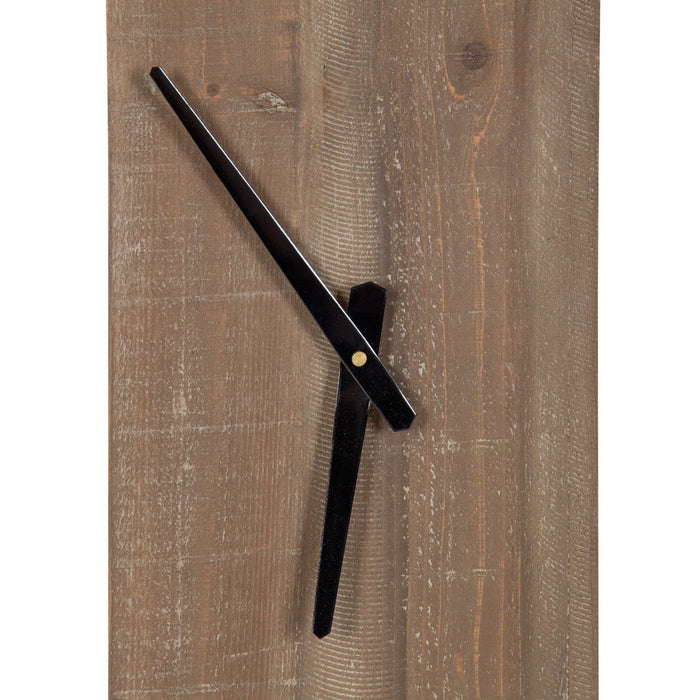 Black wall clock on a wooden panel