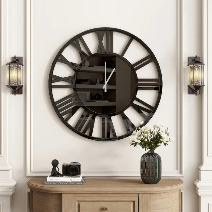 Large black wall clock with Roman numerals on a white wall above a wooden console table.
