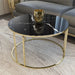 Round black marble coffee table with gold metal base.