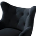 Close-up of a black upholstered chair with buttoned details on a white background