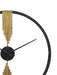 Decorative wall clock with gold accents and black hands on a white background