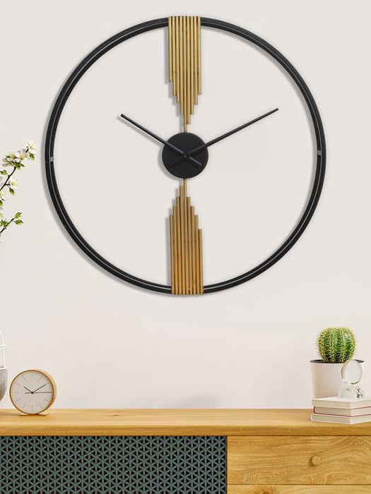 Decorative wall clock with gold accents on a white wall