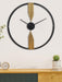 Decorative wall clock with gold accents on a white wall