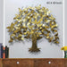 Decorative metal tree wall art with gold leaves on a plain background