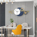 Modern dining room with a decorative wall clock featuring geometric designs.