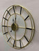 Decorative wall clock with gold frame and black hands on a light gray background