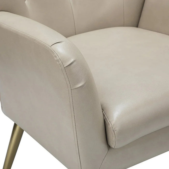 Close-up of a cream accent chair with a white background