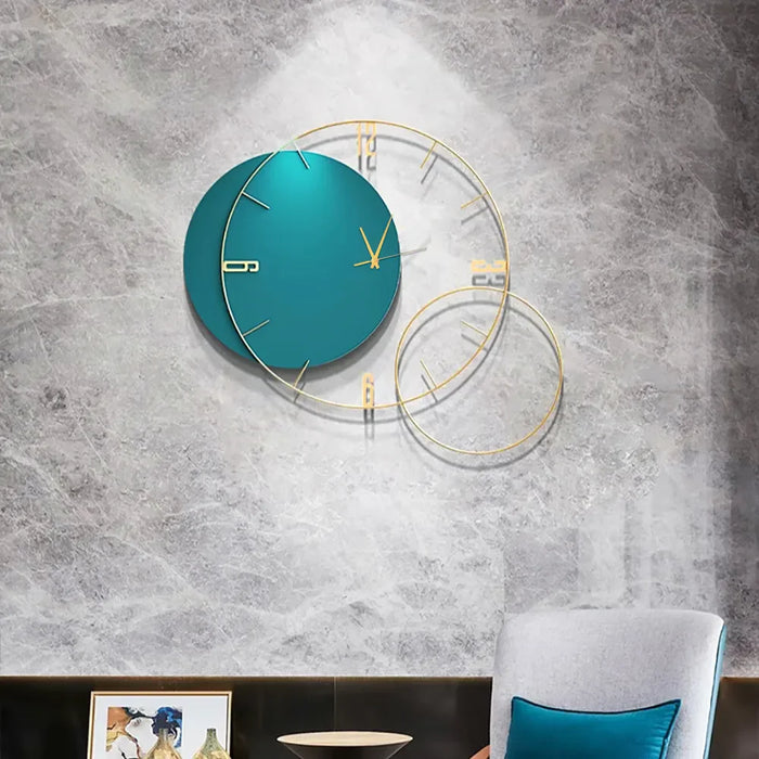 Teal wall clock with gold accents on a gray textured wall
