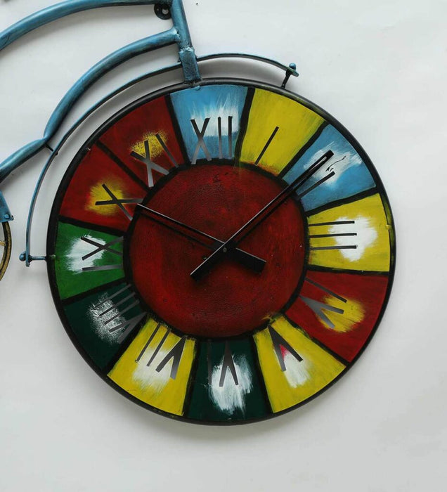 Colorful wall clock with Roman numerals on a white background