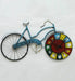 Colorful bicycle-shaped wall clock on a white background