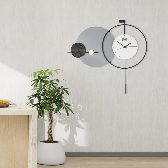 Modern wall clock with decorative elements on a light gray wall.