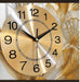 Gold wall clock with decorative elements on a light background