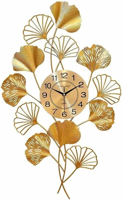 Decorative wall clock with gold leaf design on a white background