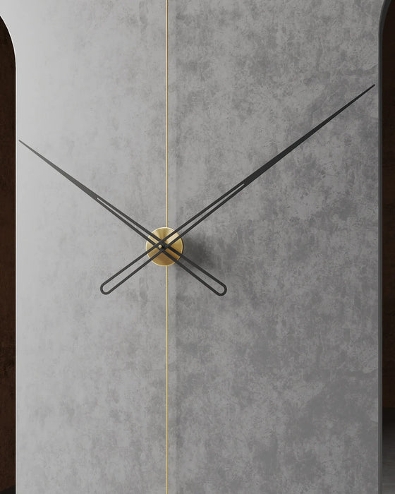 Wall clock with black and gold hands on a gray concrete background
