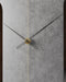 Wall clock with black and gold hands on a gray concrete background