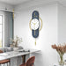 Modern wall clock with blue and gold design in a stylish room.