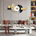 Decorative wall clock in a modern living room setting with a sofa and coffee table.