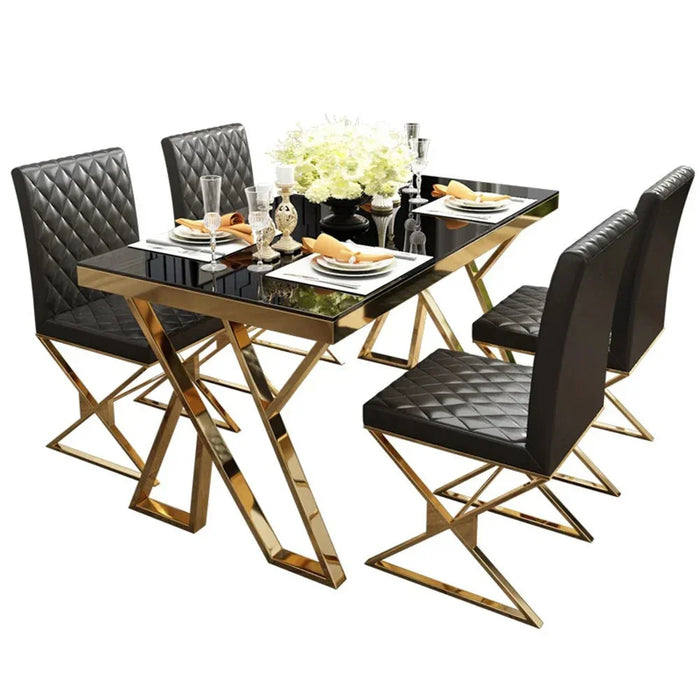Dining table set with black chairs and gold legs on a white background