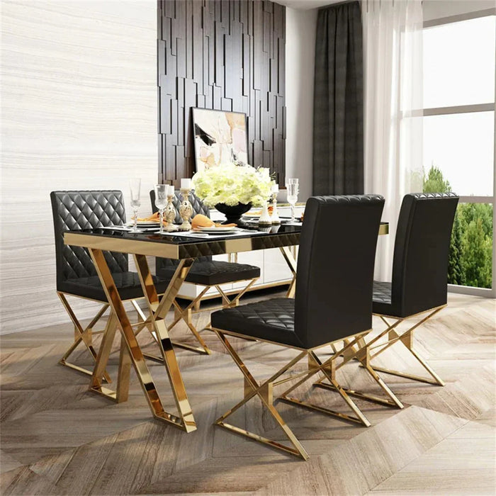 Modern dining room with a gold and black table and chairs.