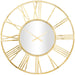Gold wall clock with Roman numeral design on a white background