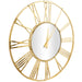 Gold wall clock with Roman numeral design on a white background