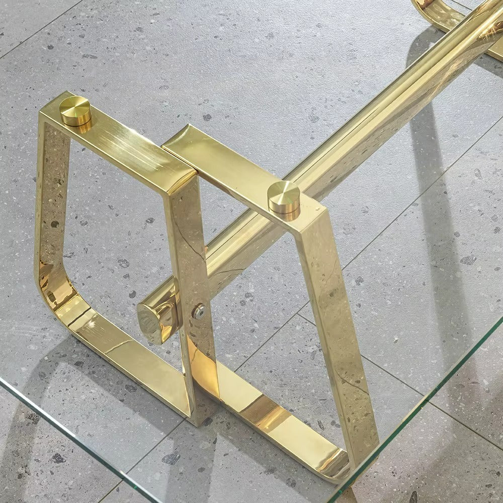 Gold metal frame on a glass table with a concrete floor background