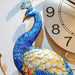 Decorative peacock wall clock with a gold frame on a light background