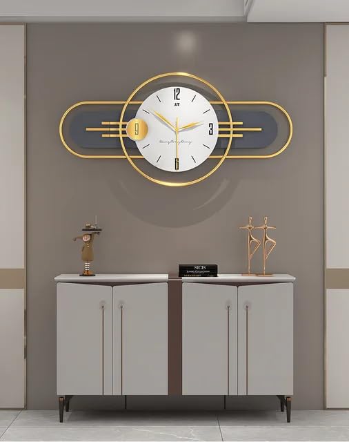 Decorative wall clock with gold frame on a gray wall above a cabinet.