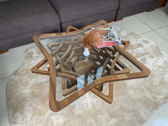 Wooden coffee table with glass top in a living room setting