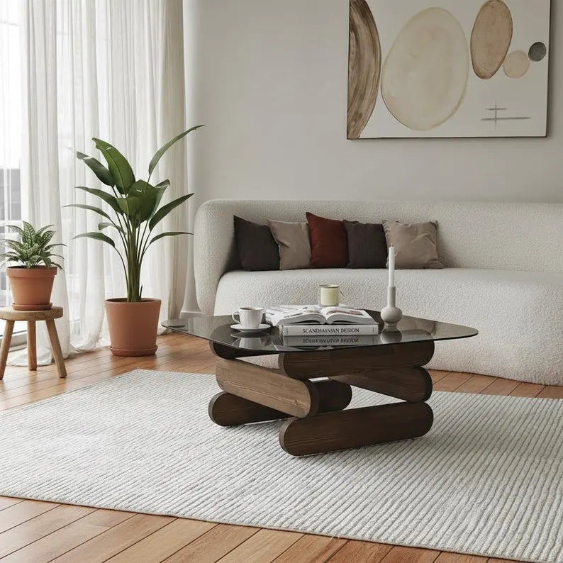 Modern living room with a coffee table, plants, and a sofa.