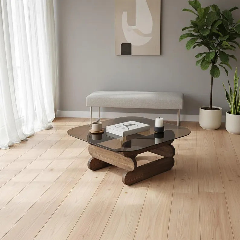 Modern living room with a wooden coffee table, gray sofa, and decorative plants.