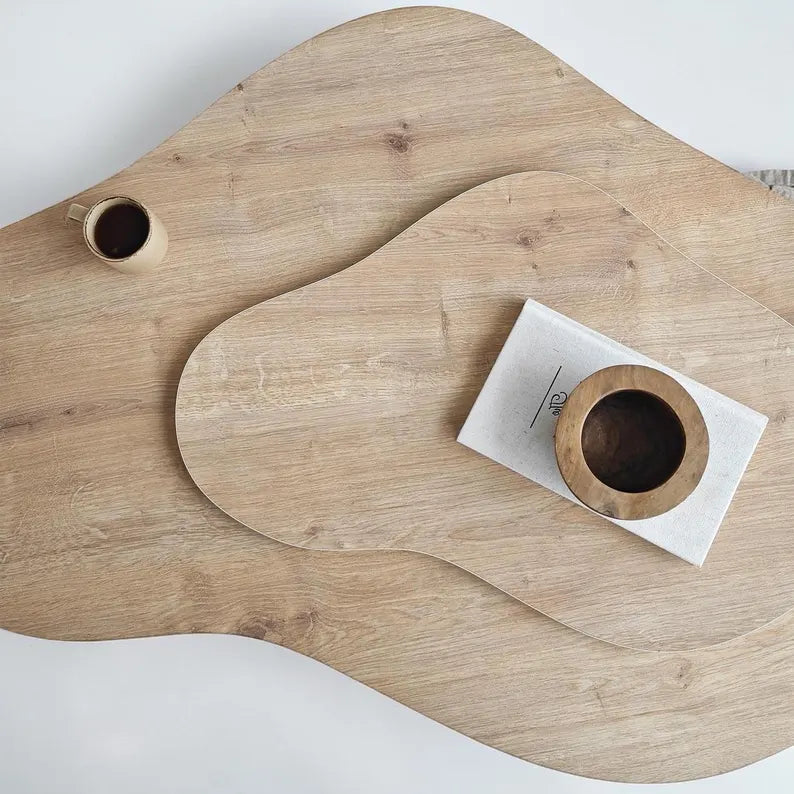 Wooden cutting board with two wooden bowls on a white background