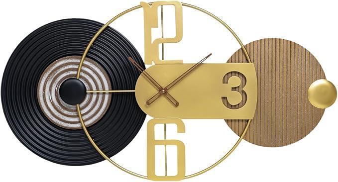Modern wall clock with gold and black design on a white background