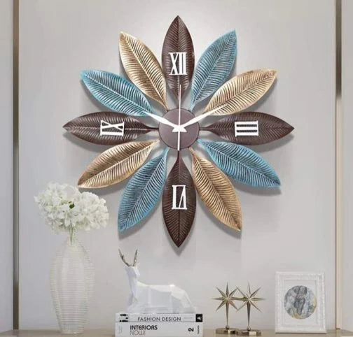 Decorative wall clock with leaf design on a wall