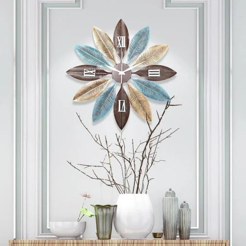 Decorative wall clock with floral design on a wall with decorative vases below.