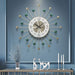 Decorative wall clock with gold and green accents on a blue wall.